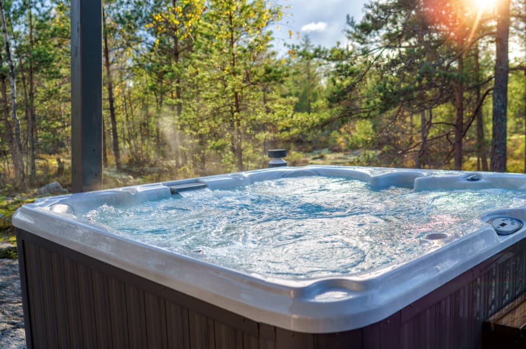 Outdoor hot tub maintenance at a wooded rental
